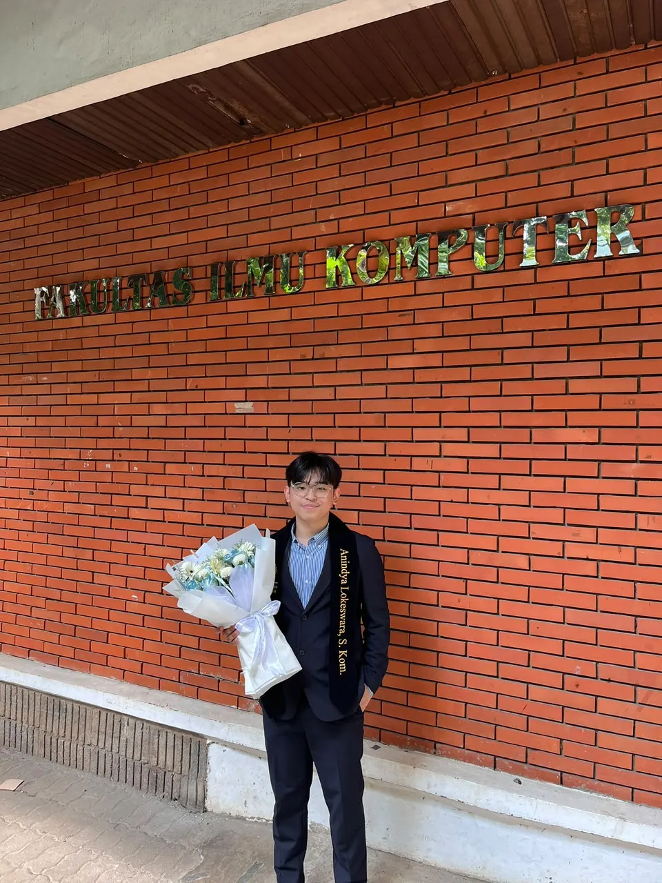 Anindya at the Faculty of Computer Science, holding flowers